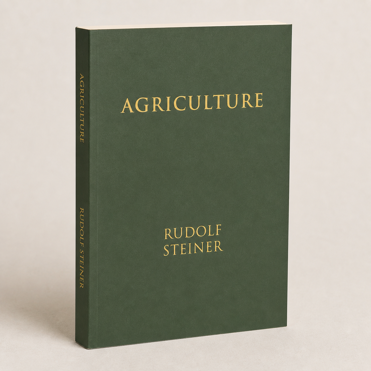Agriculture by Rudolf Steiner paperback on a softly lit off-white background
