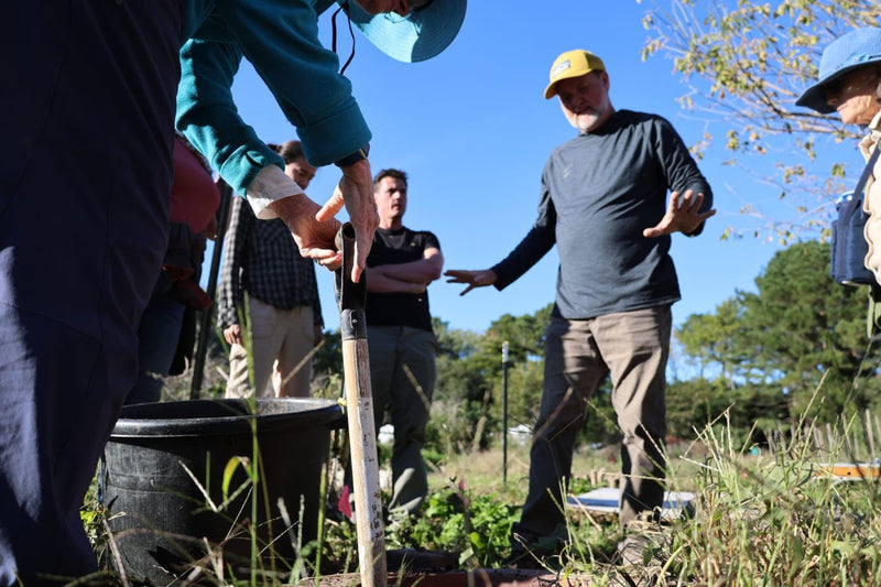 Participants learning to make biodynamic barrel compound during an outdoor workshop