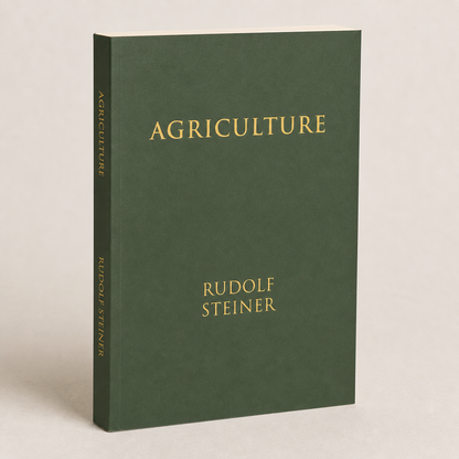 Agriculture by Rudolf Steiner paperback on a softly lit off-white background