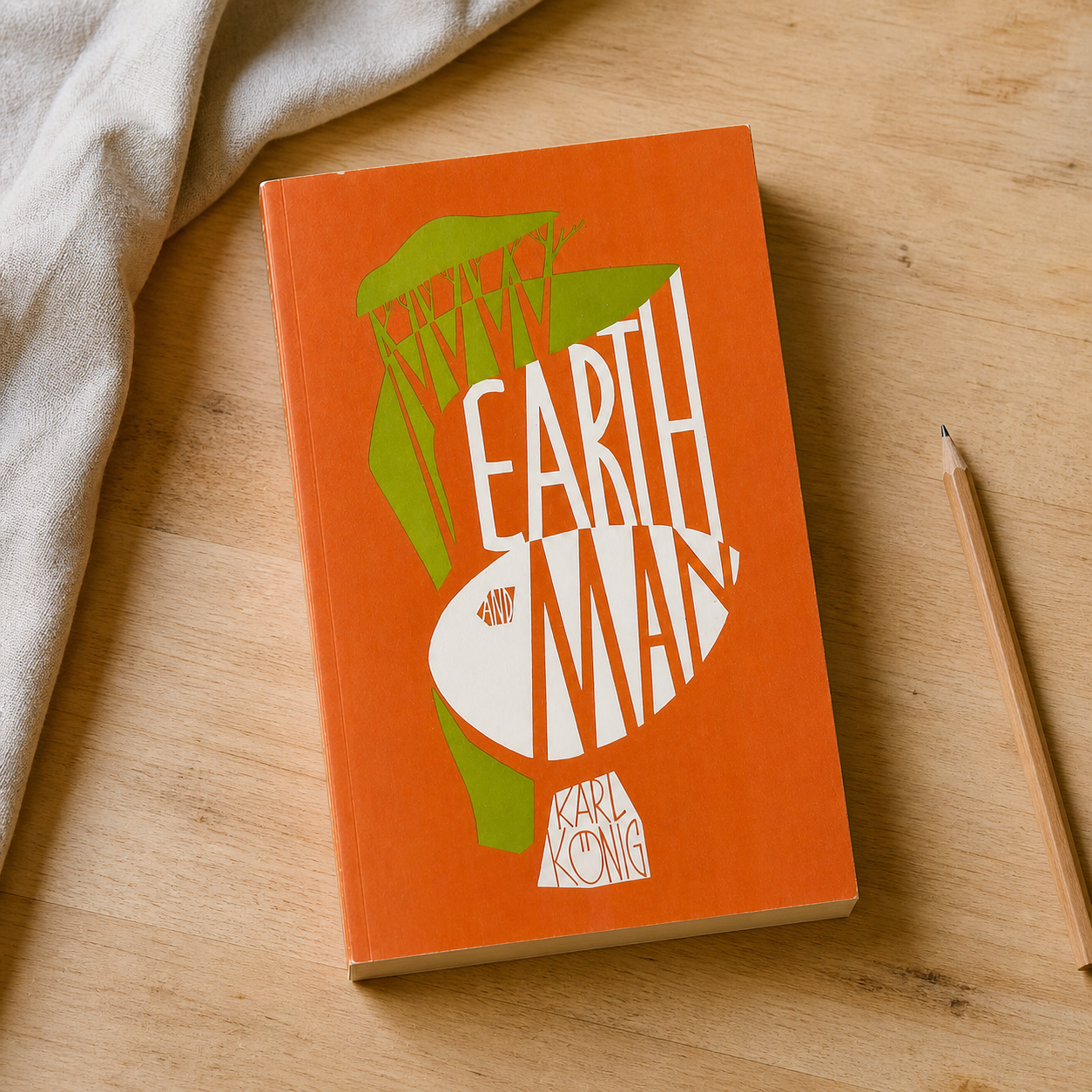 Earth and Man paperback on a naturally lit reading table