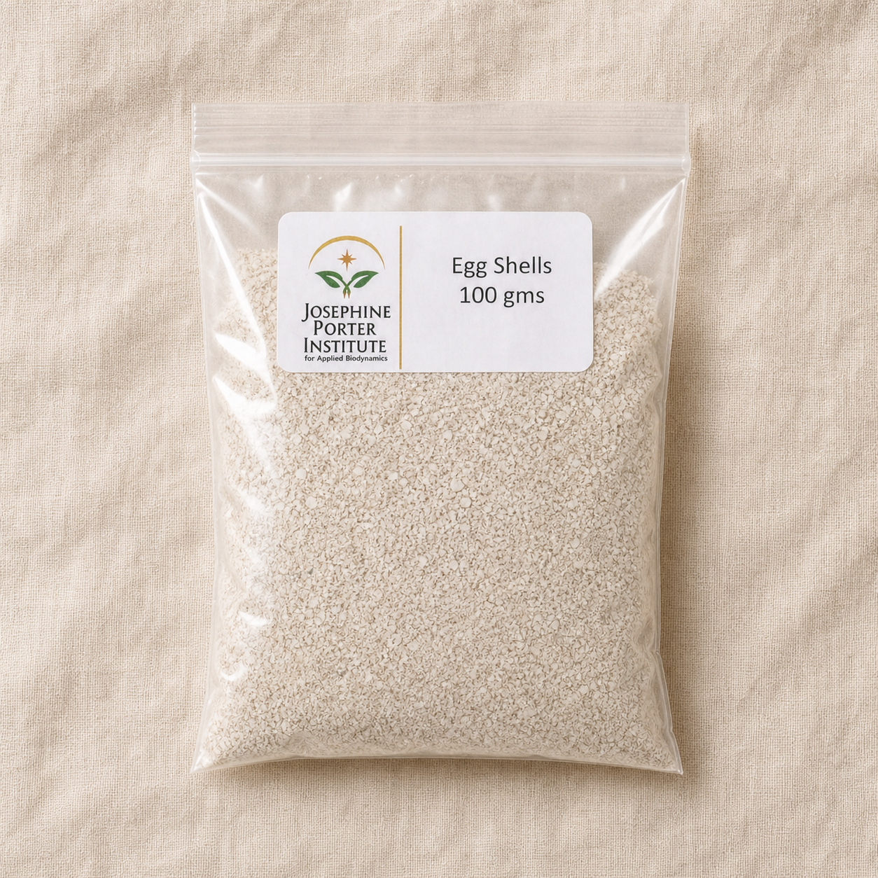 Eggshells 100 g packet and finely crushed eggshell texture, overhead view