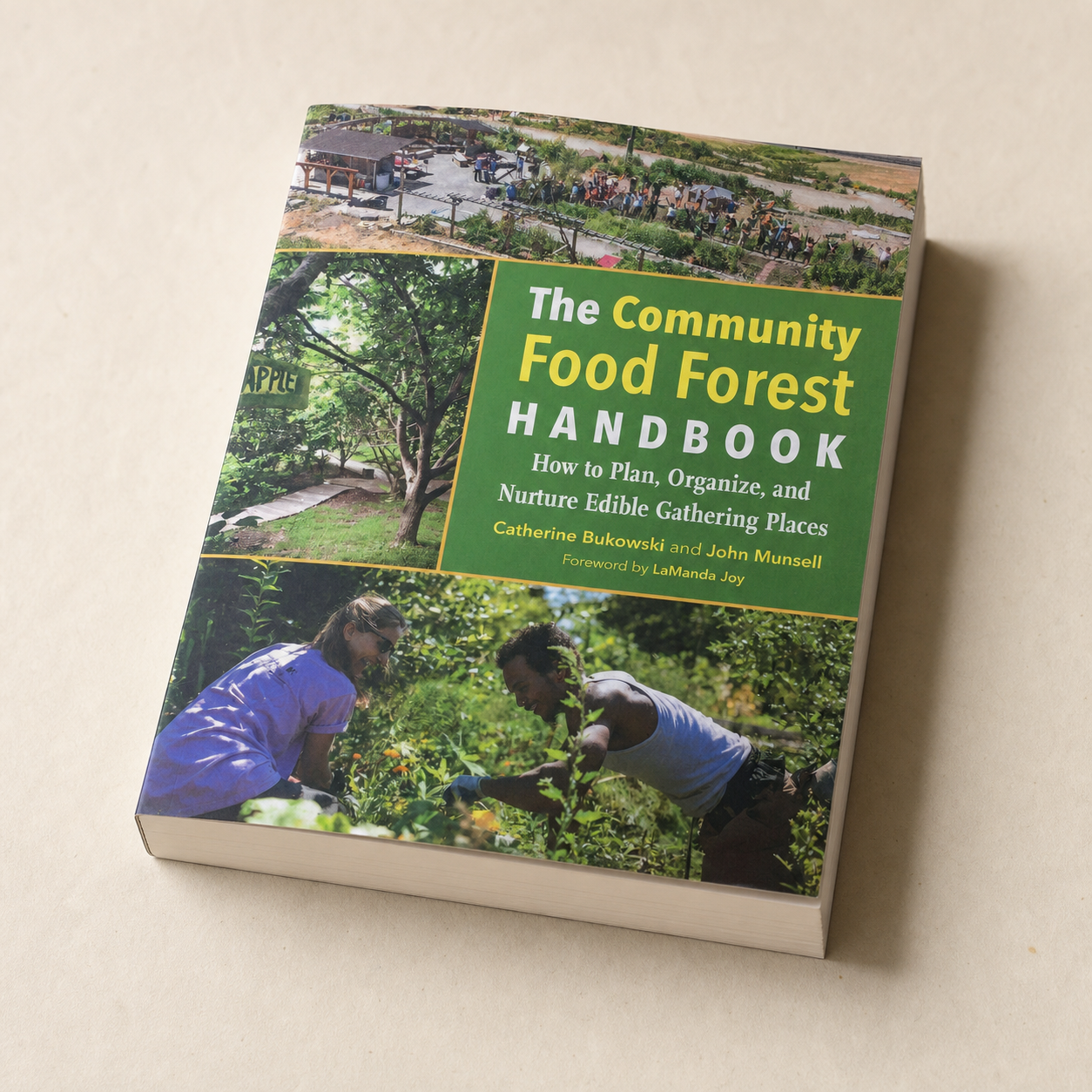 The Community Food Forest Handbook paperback, tactile page-edge detail