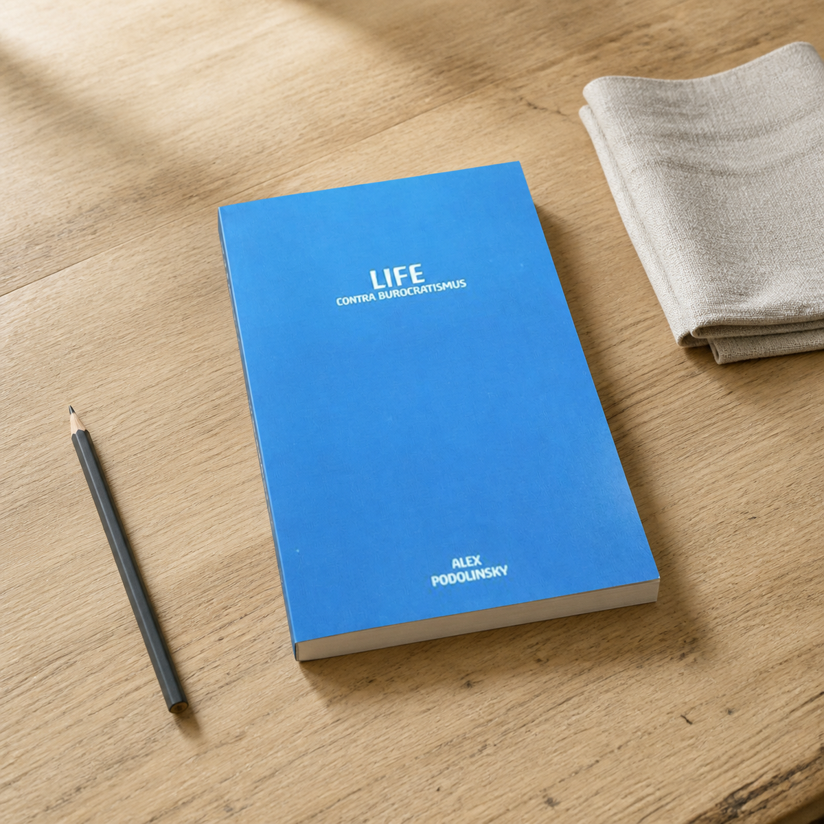 Life Contra Burocratismus by Alex Podolinsky — slim-to-medium paperback on a natural reading desk