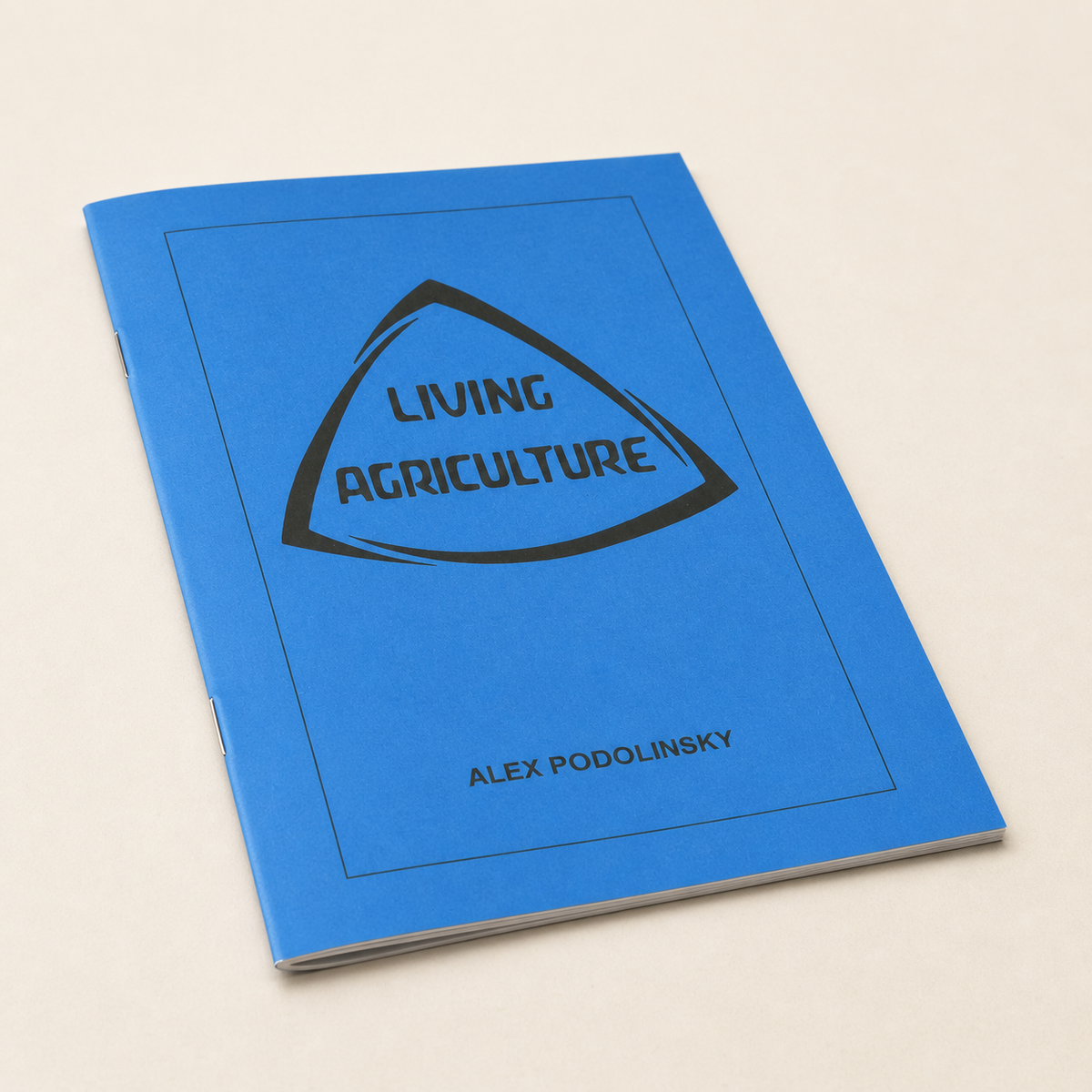 Living Agriculture — thin 32-page A4 stapled pamphlet with its modest page edge visible