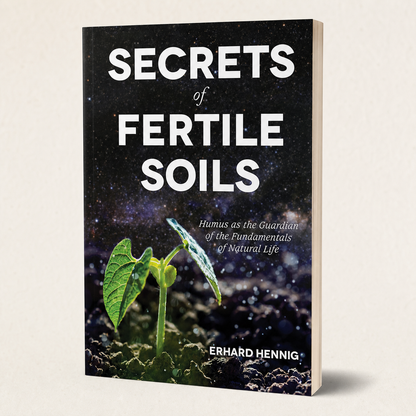 Secrets of Fertile Soils paperback on a softly lit off-white background
