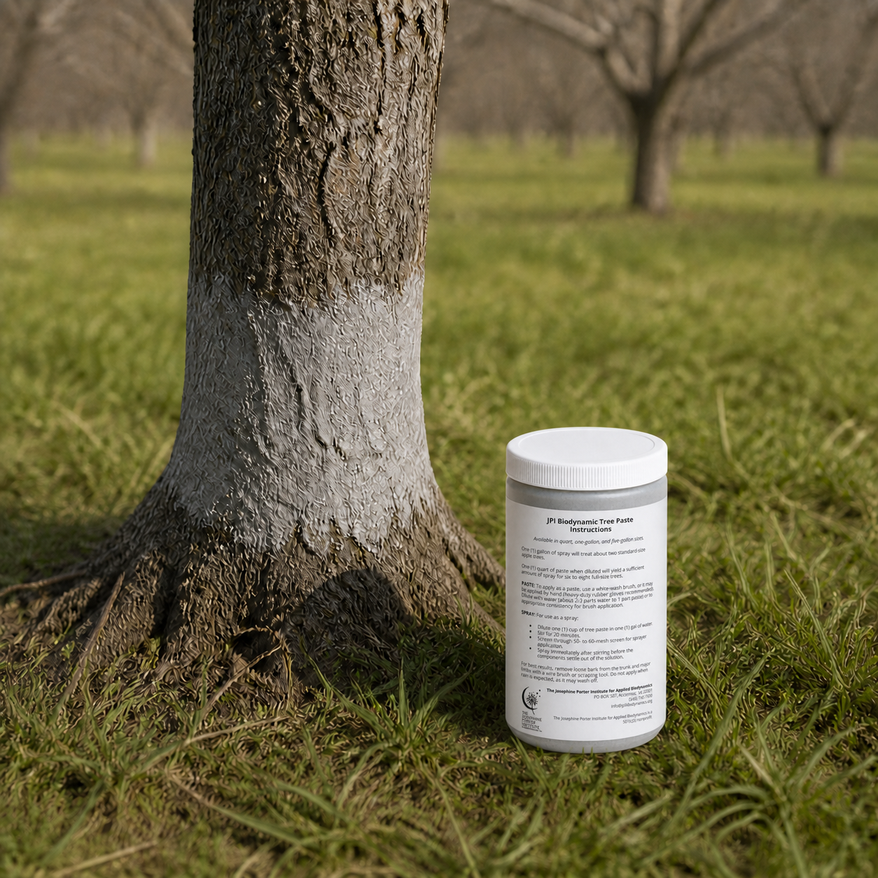 JPI Biodynamic Tree Paste container with instruction label beside a protected orchard tree