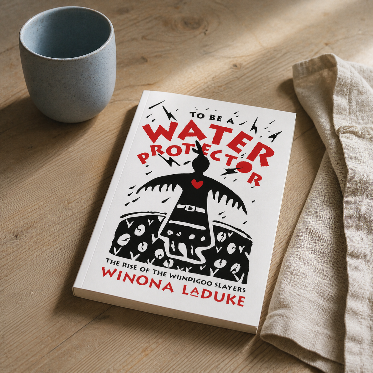 To Be a Water Protector paperback on a naturally lit reading table