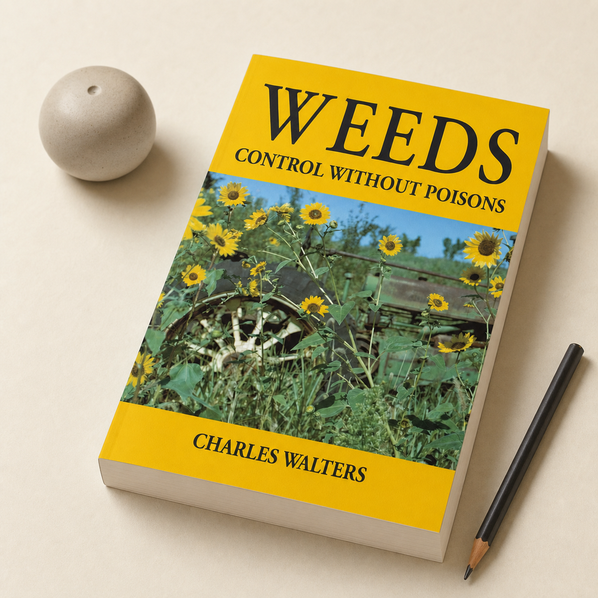 Weeds: Control Without Poisons — 352-page, 25 mm paperback in a natural desk view